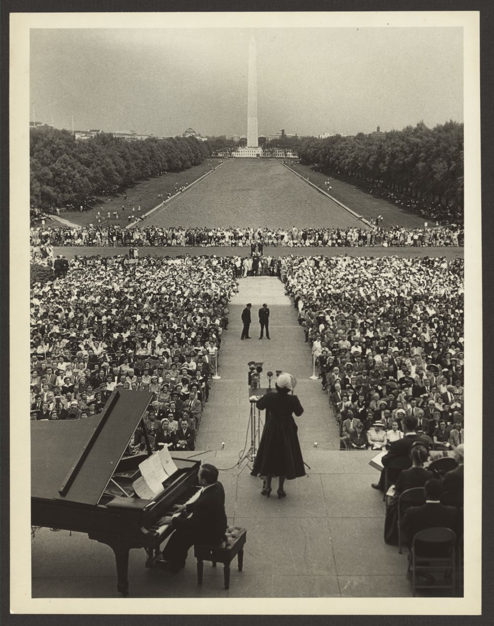 Marian Anderson, facing the Washington Monument, sings to an audience seated in front of the Lincoln Memorial, at a memorial service for Secretary of the Interior Harold Ickes, April 20, 1952. Photo by Abbie Rowe, 1952 April 20.